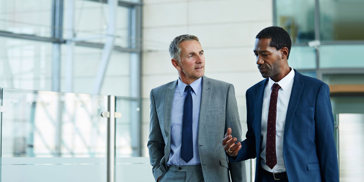 Two businessmen discussing commercial financing opportunities