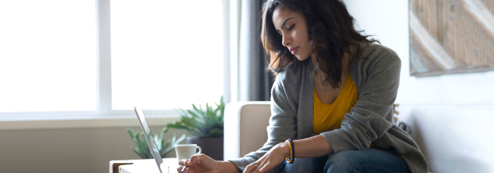Female looking at laptop for online banking Female looking at laptop for online banking