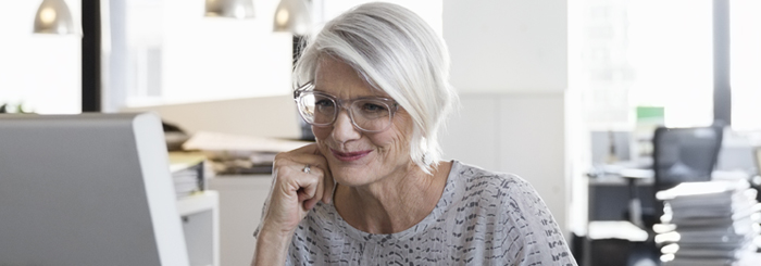 Senior female looking at computer for senior savings account Senior female looking at computer for senior savings account