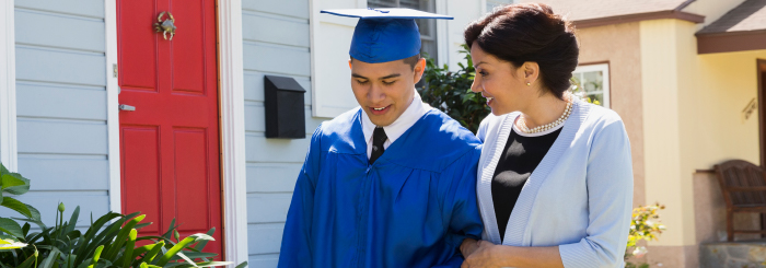 Proud mother walking her son in his student graduation gown Proud mother walking her son in his student graduation gown
