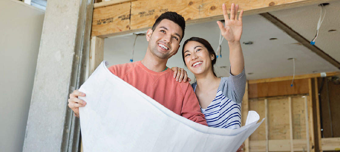 Smiling optimistic couple renovating their home