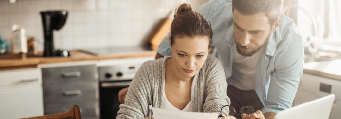 Couple researching mortgage assistance and payment help Couple researching mortgage assistance and payment help