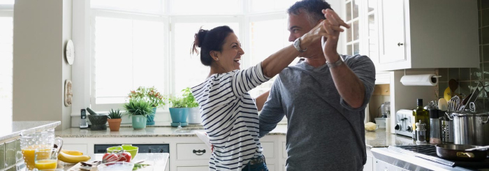 Happy couple dancing in their kitchen Happy couple dancing in their kitchen