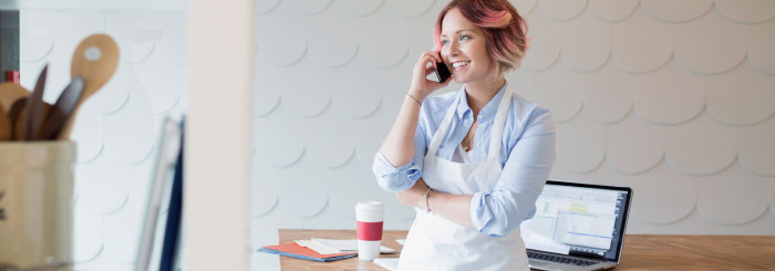 Female small business owner on her phone for SBA financial services 
