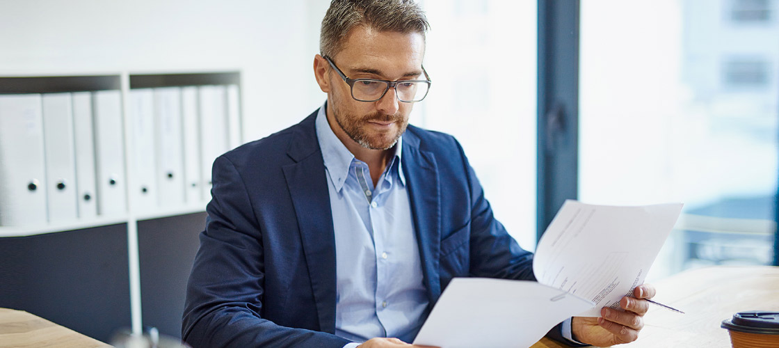 Business man reviewing documents in his office 