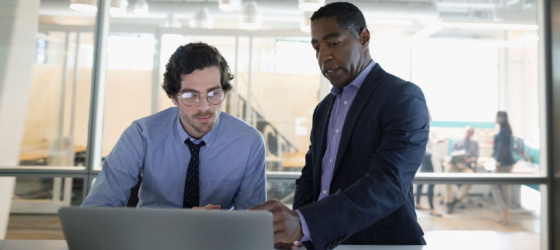 Business co-workers looking at computer to use ACH blocks and filters
