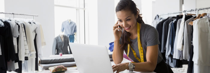 Small business owner on her laptop for online banking and electronic statements Small business owner on her laptop for online banking and electronic statements