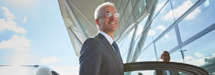 Smiling business man arriving at airport Smiling business man arriving at airport