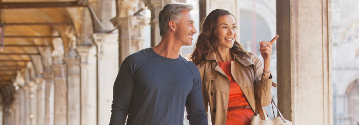 Happy couple traveling and shopping in foreign country Happy couple traveling and shopping in foreign country
