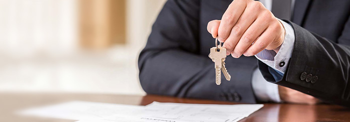 Real estate financing agent holding a set of keys Real estate financing agent holding a set of keys