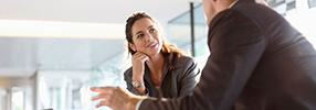 Investment planning consultant listening to her coworker