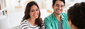 Smiling couple receiving advice for saving for retirement